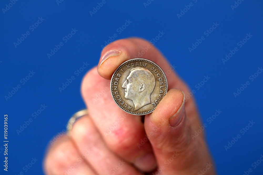 Fingers hold old coin from yugoslavia kingdom Fingers hold old coin from yugoslavia kingdom
