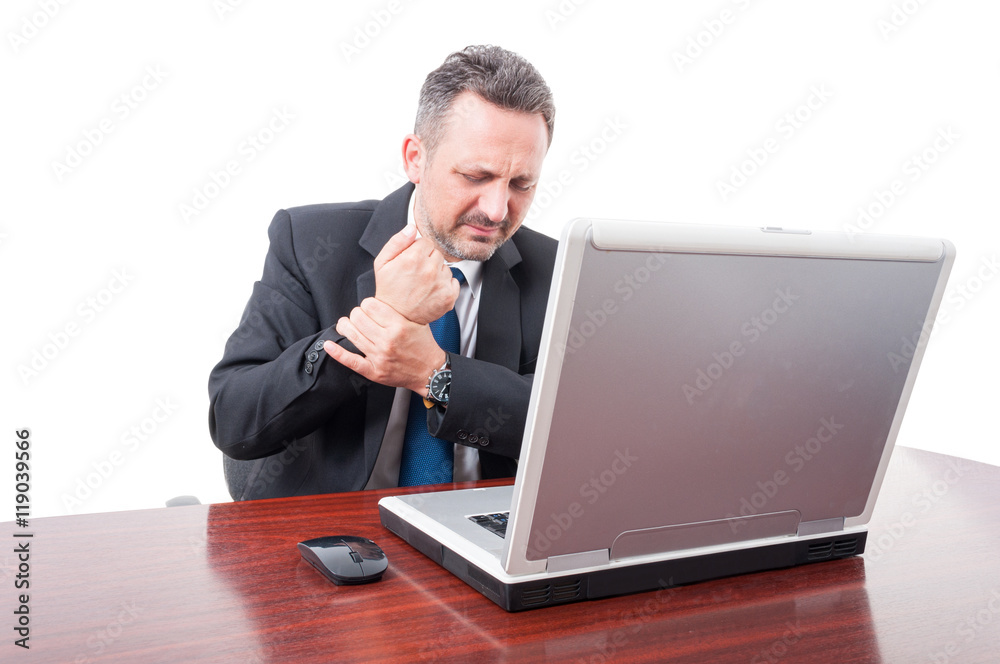 Stressed businessman having medical problem on wrist Stressed businessman having medical problem on wrist