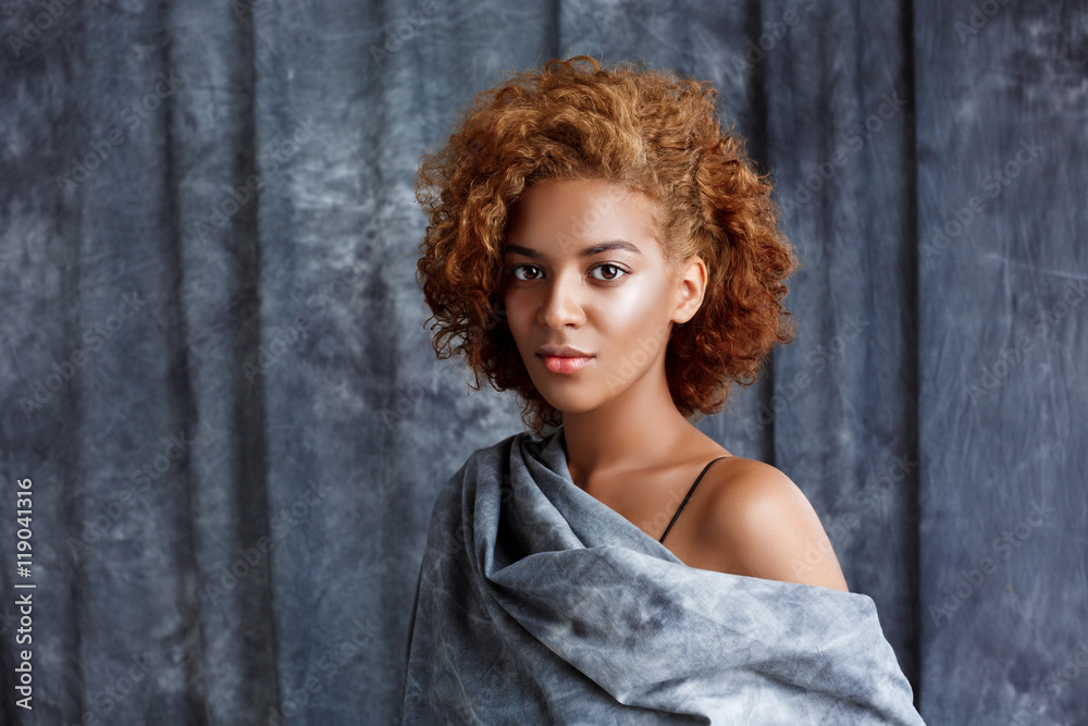 Young beautiful african girl posing, wrapping up in grey cloth. Young beautiful african girl posing, wrapping up in grey cloth.