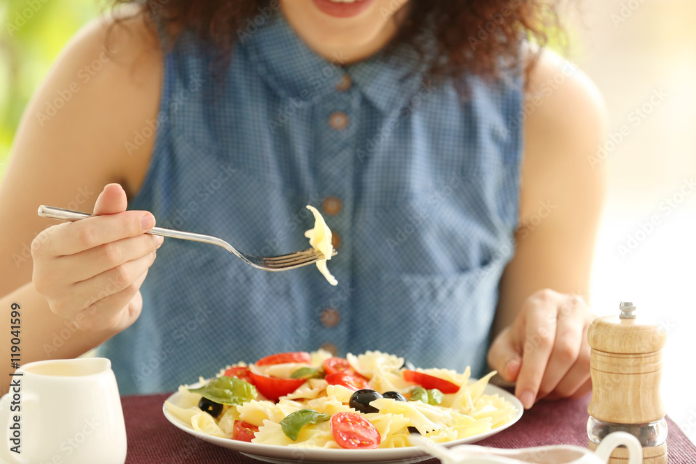 Woman eating delicious pasta in restaurant Woman eating delicious pasta in restaurant