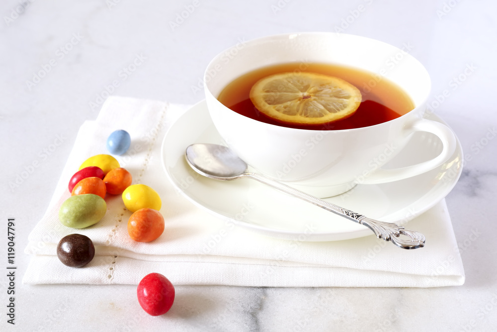 Cup of tea and multicolored chocolate drops Cup of tea and multicolored chocolate drops