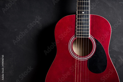 Still life photography : Part of old acoustic guitar on dark background