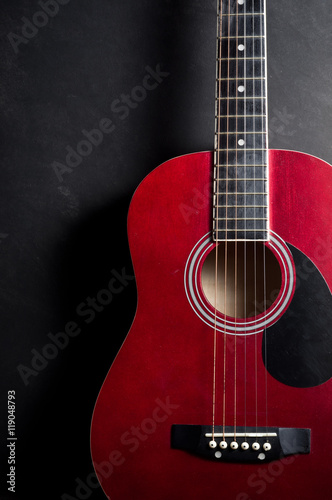 Still life photography : Part of old acoustic guitar on dark background