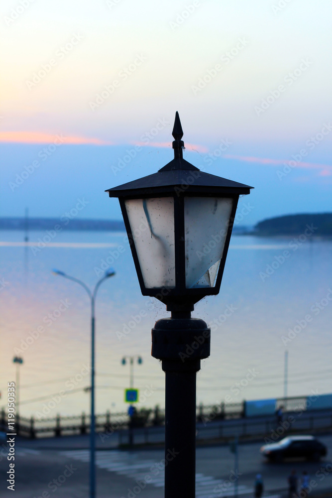 sunset on the beach, old lantern