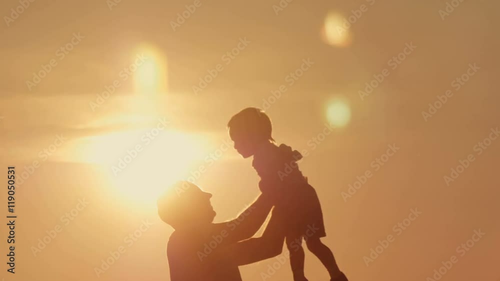 father and son silhouettes play at sunset beach. Happy family father and son silhouettes play at sunset beach. Happy family