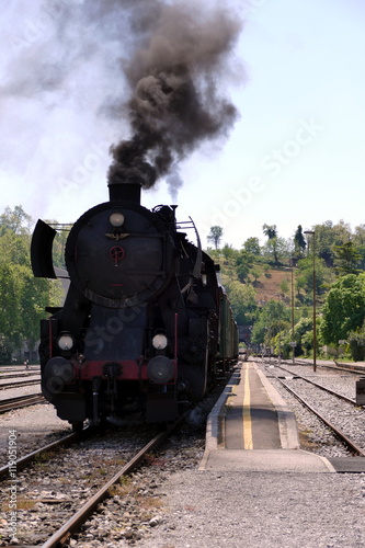 Fototapeta Naklejka Na Ścianę i Meble -  Steam locomotive on station with black smoke