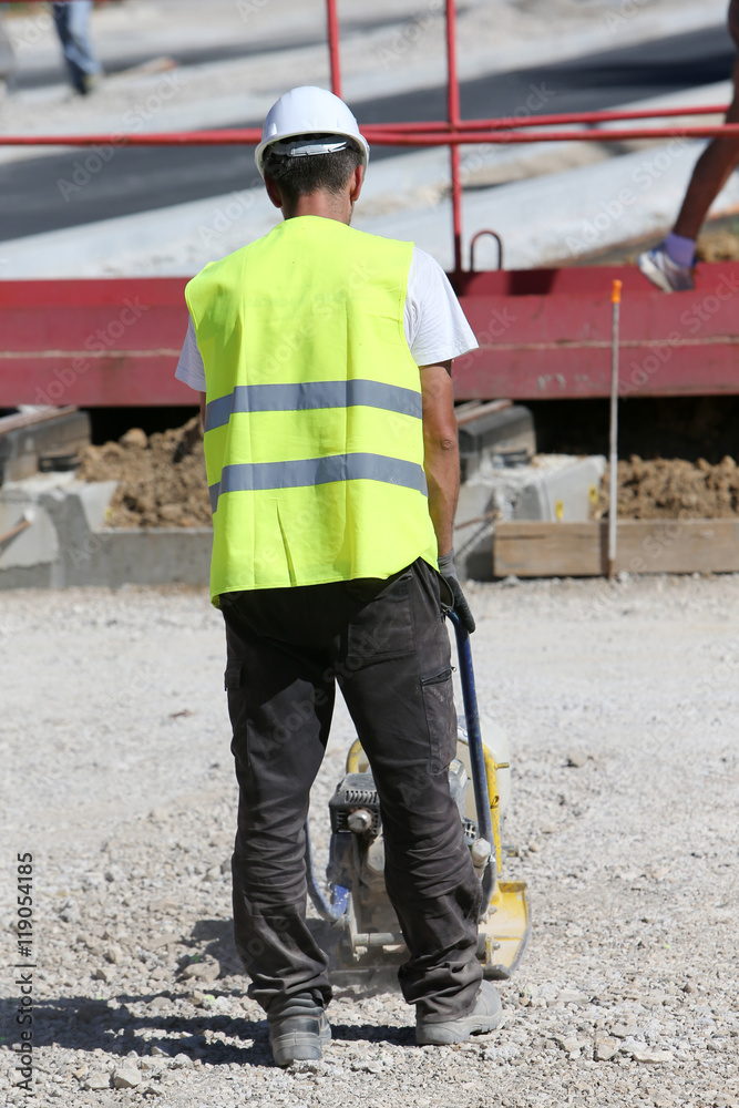 Man with a vibrating plate Man with a vibrating plate