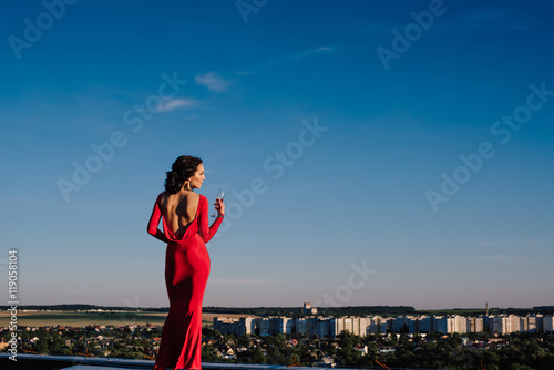 young beautiful brunette woman in a red dress photo