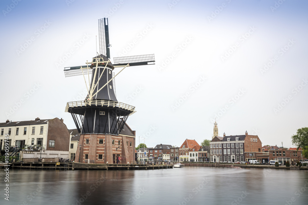Haarlem by the canal with windmill, The Netherlands