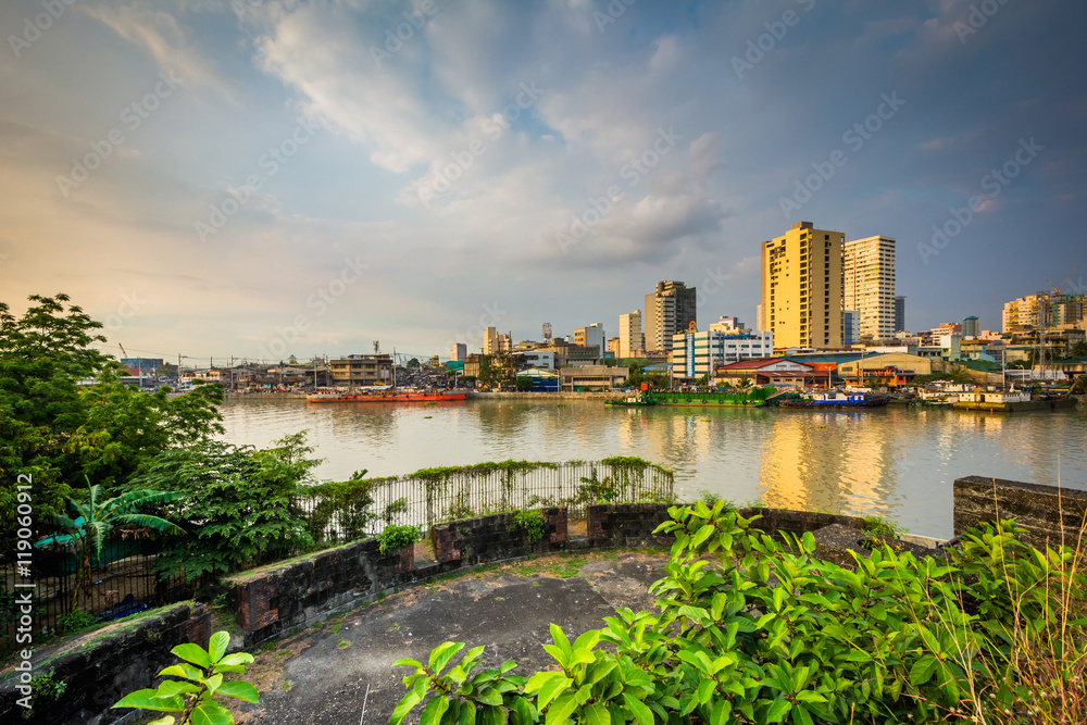Ruins at Fort Santiago and buildings along the Pasay River, in I