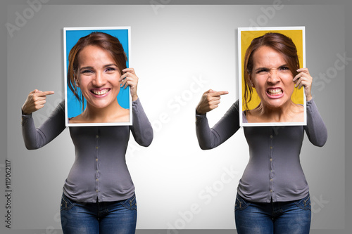 Girl holding a picture of her face happy and angry