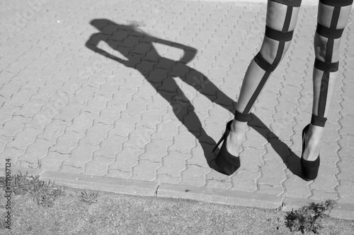 shadow girl and feet in frame, photo black white photo