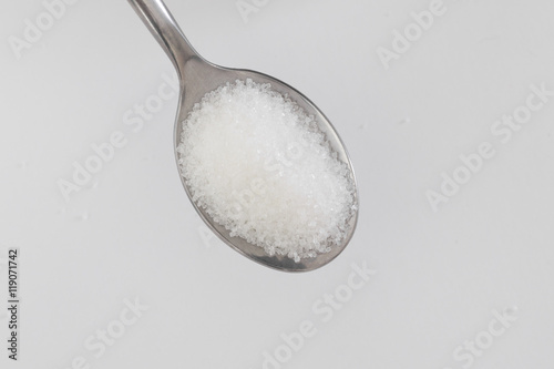spoon of sugar on a white background