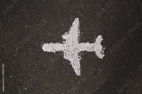 Top view of painted white aircraft on asphalt road