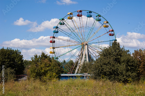 Big empty Ferris wheel in the park against the sky.