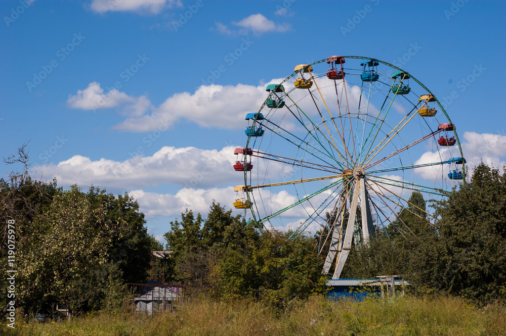 Big empty Ferris wheel in the park against the sky. Big empty Ferris wheel in the park against the sky.