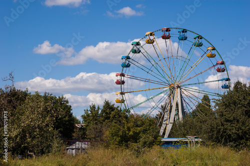 Big empty Ferris wheel in the park against the sky.