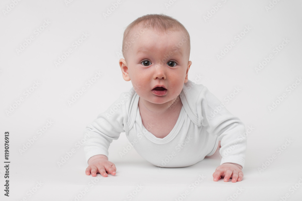 baby on a white background in a white pajamas baby on a white background in a white pajamas
