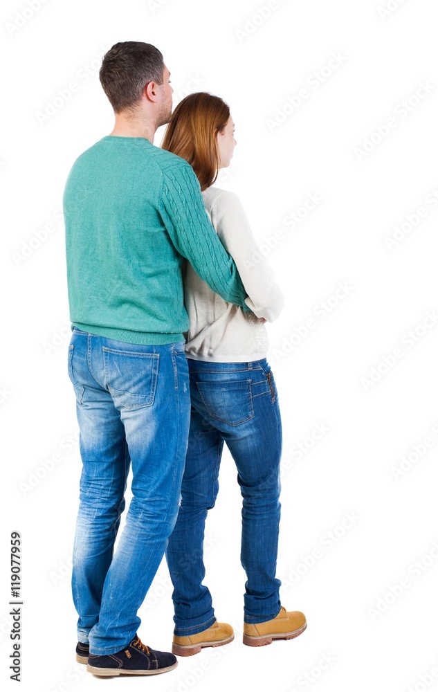 Back view of young embracing couple (man and woman) hug and look into the distance. beautiful friendly girl and guy together. Rear view people collection. backside view of person. Isolated over Back view of young embracing couple (man and woman) hug and look into the distance. beautiful friendly girl and guy together. Rear view people collection. backside view of person. Isolated over