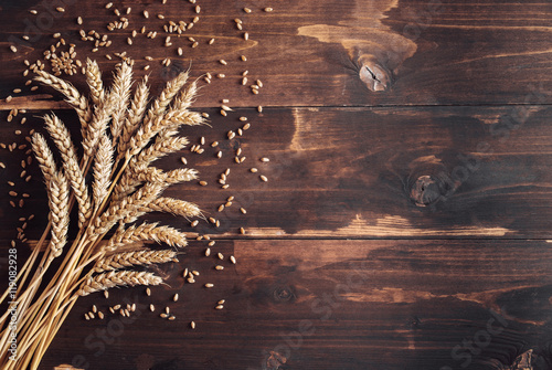 Ripe wheat eras on distressed wooden background