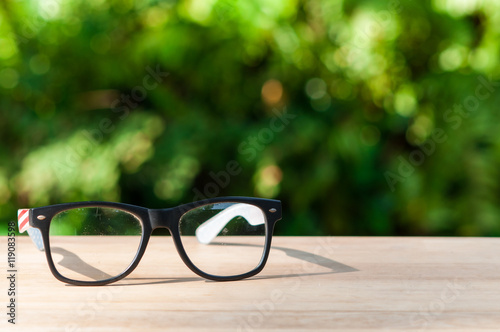 Eyeglasses on wooden table.