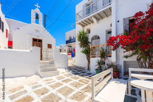 Square with church on whitewashed street with typical Greek architecture in beautiful Mykonos town, Cyclades islands, Greece