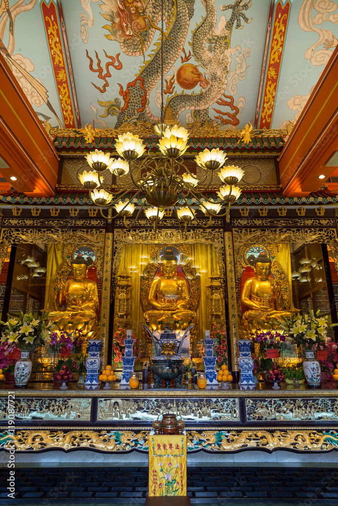 Buddha statues and altar at the Main Shrine Hall of Buddha at the Po Lin Monastery on Lantau Island in Hong Kong, China, viewed from the front.
