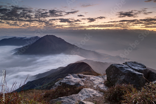 Clouds rolling over mountain on Lantau Island, viewed from the Lantau Peak (the 2nd highest peak in Hong Kong, China) at dawn.