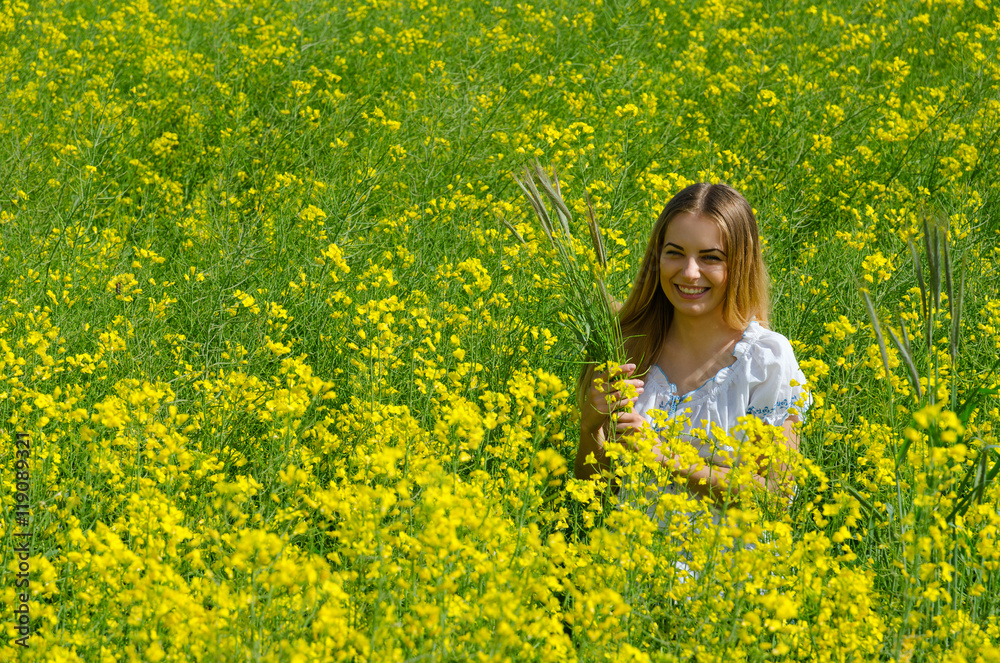 Beautiful girl with ears of corn on flowering field Beautiful girl with ears of corn on flowering field