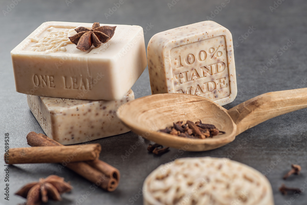 handmade ornamental soaps with cinnamons and anise on black background, product of cosmetics and body care handmade ornamental soaps with cinnamons and anise on black background, product of cosmetics and body care