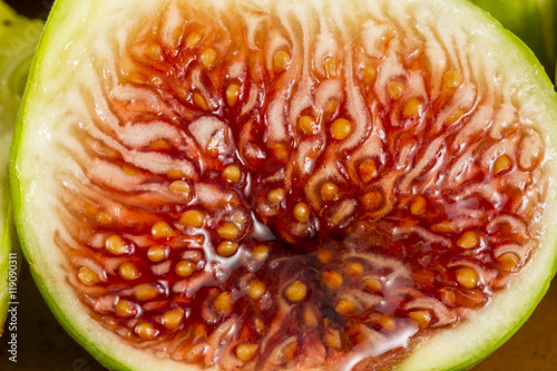 Seeds and red flesh of a fresh fig cut in half
