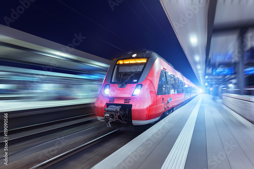 Modern high speed red passenger train at night