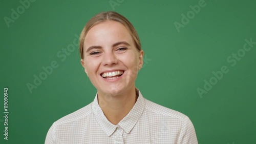 Close up young woman widely smiling, green screen background