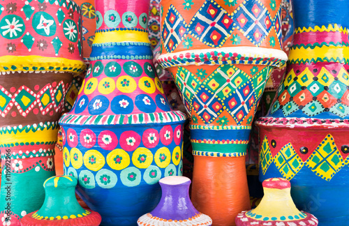 Front view showing a composition of artistic painted colorful handcrafted pottery vases