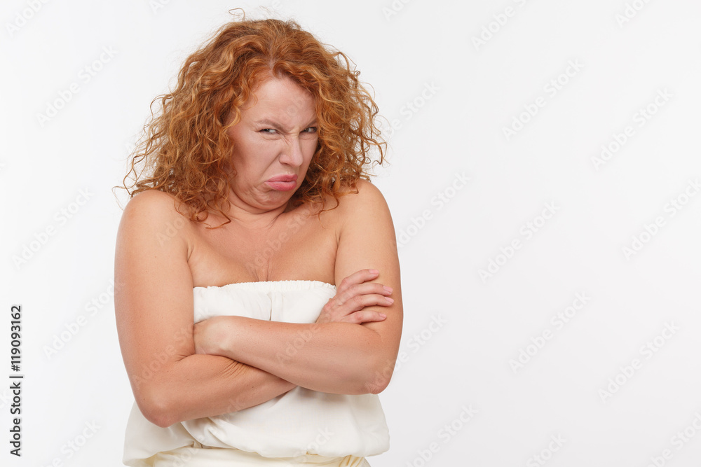 Portrait of disdaining mature or senior woman posing isolated on