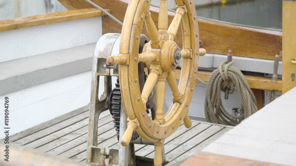 The wooden steering wheel with the motor on the back of it found on the front deck of the ship