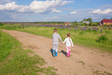 Cute preschool children in a field of purple lupine flowers