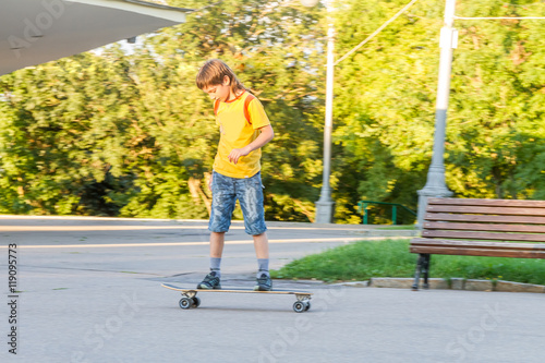 young boy skateboarding on natural background