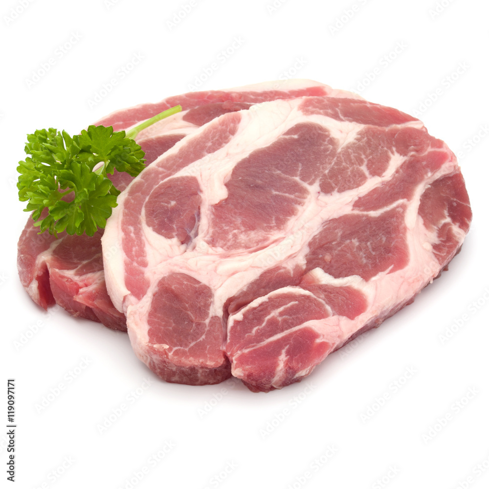 Raw pork neck chop meat with parsley herb leaves garnish isolate Raw pork neck chop meat with parsley herb leaves garnish isolate