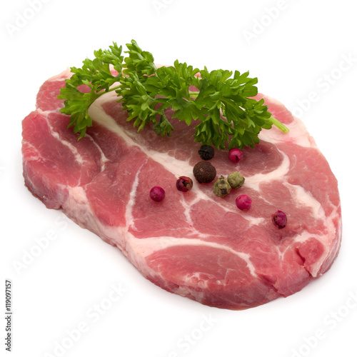 Raw pork neck chop meat with parsley herb leaves and peppercorn