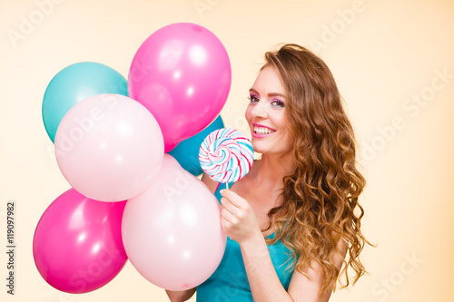 Woman with colorful balloons and lollipop