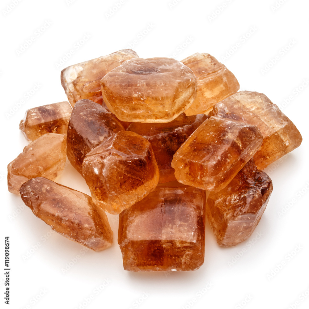 Brown caramelized lump cane sugar cube isolated on white backgro Brown caramelized lump cane sugar cube isolated on white backgro