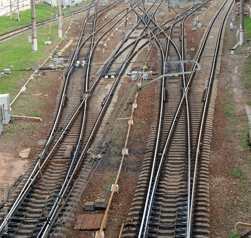 Industrial landscape with railroad tracks on concrete railway sleepers, arrows and track equipment top view