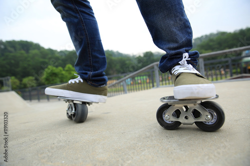 freeline skateboarder legs riding on freeline at skatepark photo