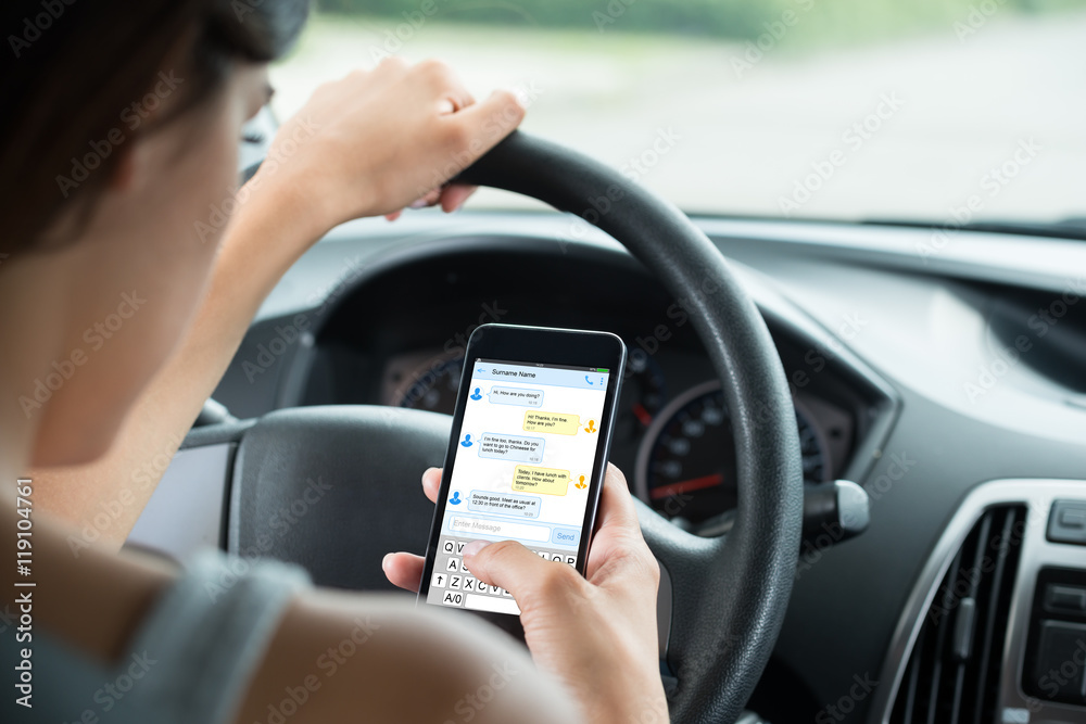 Close-up Of Woman Typing Text Message On Mobile Phone