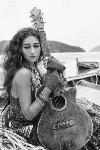 Atrractive young gypsy woman with guitar