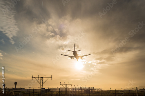 Airplane landing at dusk.