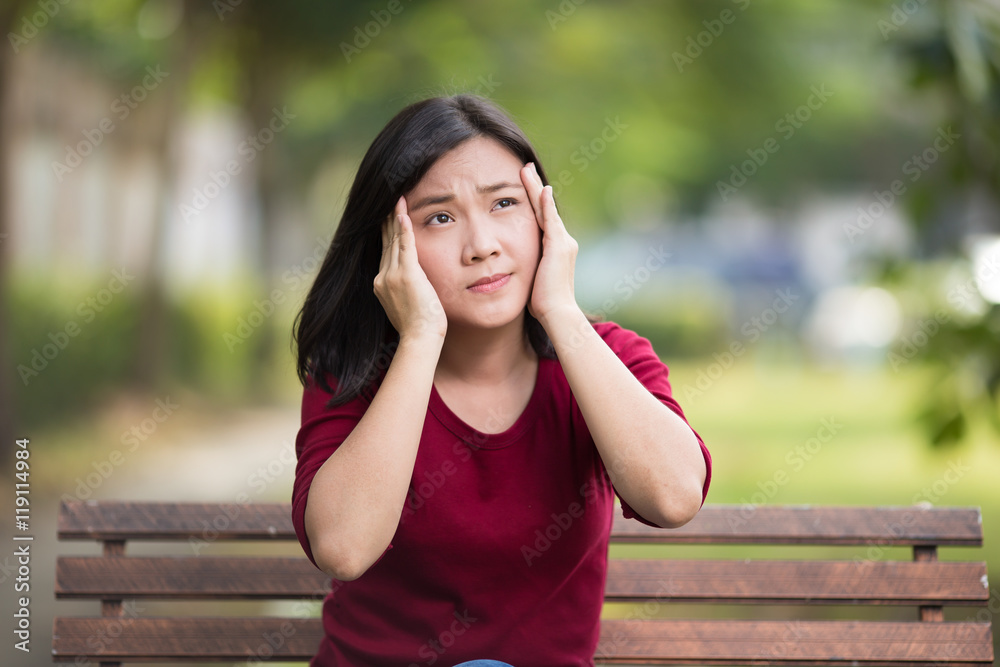 Woman Has Head Ache Sitting on Bench at Park Woman Has Head Ache Sitting on Bench at Park