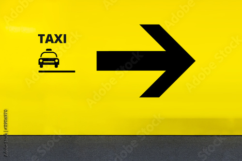 Airport Sign With Taxi Icon and Arrow
