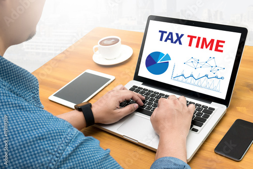 TAX TIME   Business team hands at work with financial reports